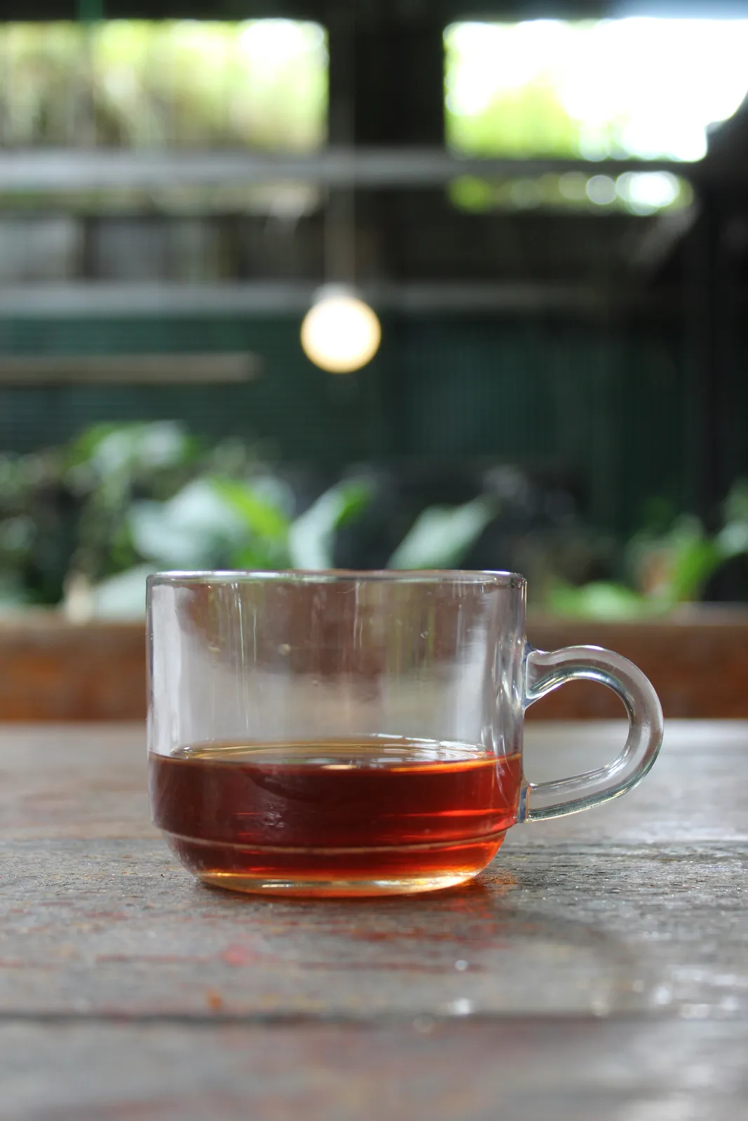 A clear glass cup of Ceylon tea